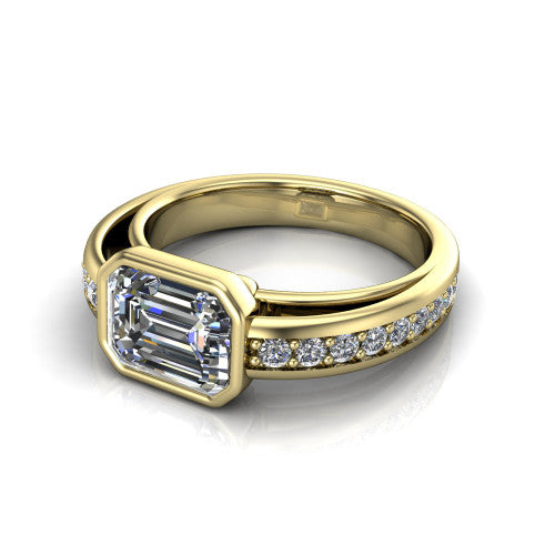 Isabel emerald-cut classic engagement ring in 18K Yellow Gold, three-quarter perspective showing the emerald-cut center diamond in a full bezel above a split diamond band