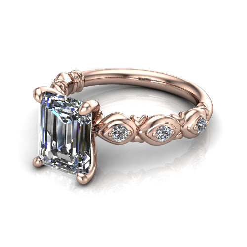 Nyla emerald-cut solitaire engagement ring in 14K Rose Gold, three-quarter perspective showing the emerald-cut center diamond above a vintage marquise-station accent band