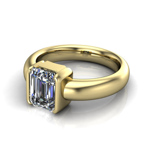 Morgan emerald-cut classic engagement ring in 18K Yellow Gold, three-quarter perspective showing the emerald-cut center diamond in a half-bezel on a wide polished band