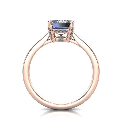 Finley emerald-cut classic engagement ring in 14K Rose Gold, through-finger front profile showing the hidden halo beneath the basket from the front