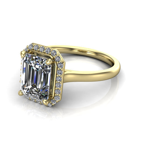 Dream emerald halo engagement ring in 18K Yellow Gold, three-quarter perspective showing the emerald center diamond in a pave halo with a leaf-inspired gallery