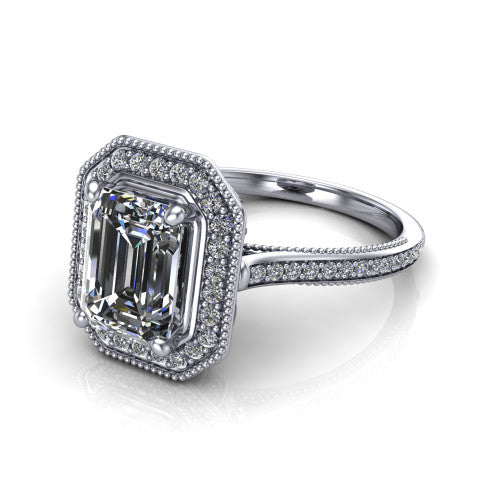 Diana emerald-cut halo engagement ring in Platinum, three-quarter perspective showing the emerald-cut center diamond in a milgrain pave halo above a pave band