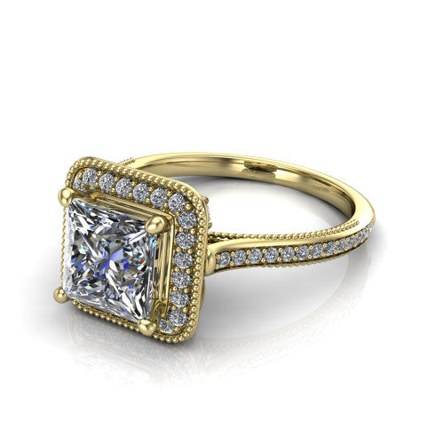 Diana princess-cut halo engagement ring in 18K Yellow Gold, three-quarter perspective showing the princess-cut center diamond in a milgrain pave halo above a pave band