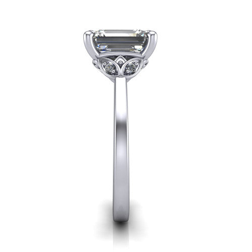 Lola emerald solitaire engagement ring in Platinum, side profile showing the petal basket and polished band