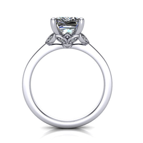 Lola emerald solitaire engagement ring in Platinum, through-finger front profile showing the petal-design basket