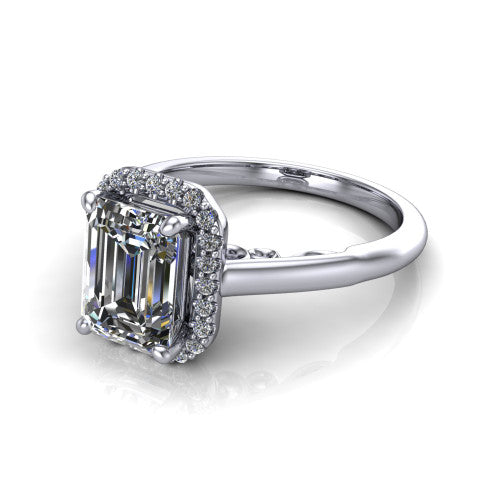 Paige emerald halo engagement ring in Platinum, three-quarter perspective showing the emerald center diamond in a pave halo above a polished band