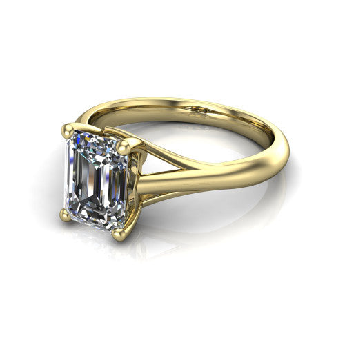 Francesca emerald-cut solitaire engagement ring in 18K Yellow Gold, three-quarter perspective showing the emerald-cut center diamond, double-claw prongs, and split shank