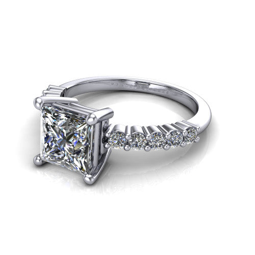 Fernanda princess solitaire engagement ring in 18K White Gold, three-quarter perspective showing the princess center diamond, 4-prong setting, and shared-prong pave band