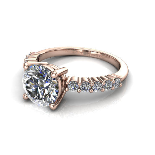 Fernanda round solitaire engagement ring in 18K Rose Gold, three-quarter perspective showing the round center diamond, 4-prong setting, and shared-prong pave band