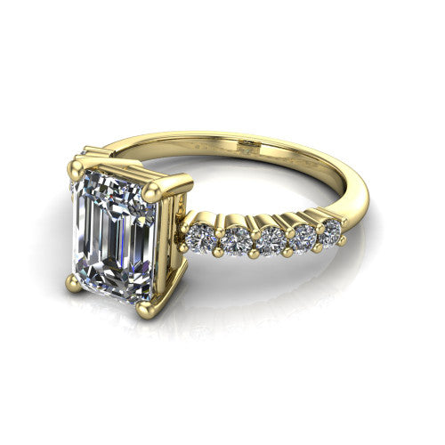 Fernanda emerald solitaire engagement ring in 18K Yellow Gold, three-quarter perspective showing the emerald center diamond, 4-prong setting, and shared-prong pave band