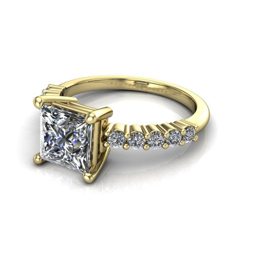 Fernanda princess solitaire engagement ring in 14K Yellow Gold, three-quarter perspective showing the princess center diamond, 4-prong setting, and shared-prong pave band
