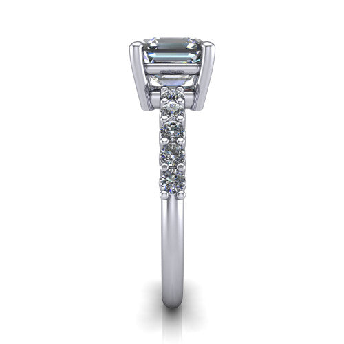 Fernanda square emerald solitaire engagement ring in 18K White Gold, side profile showing the 4-prong head and shared-prong pave band
