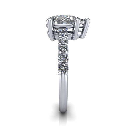 Fernanda pear solitaire engagement ring in Platinum, side profile showing the 4-prong head and shared-prong pave band