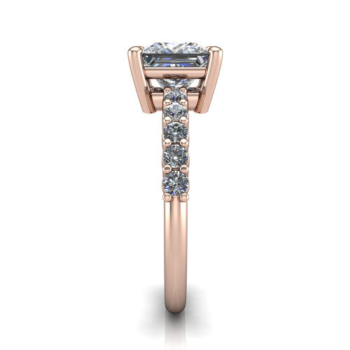 Fernanda princess solitaire engagement ring in 18K Rose Gold, side profile showing the 4-prong head and shared-prong pave band