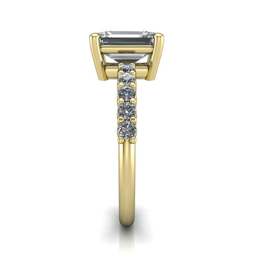 Fernanda emerald solitaire engagement ring in 18K Yellow Gold, side profile showing the 4-prong head and shared-prong pave band