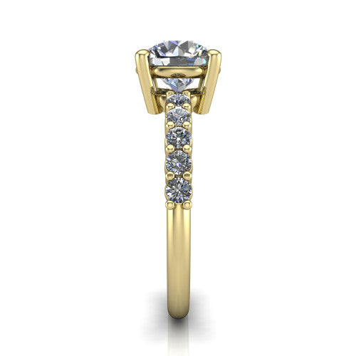 Fernanda round solitaire engagement ring in 18K Yellow Gold, side profile showing the 4-prong head and shared-prong pave band