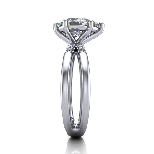 Raven pear solitaire engagement ring in Platinum, side profile showing the accent diamonds along the dual band