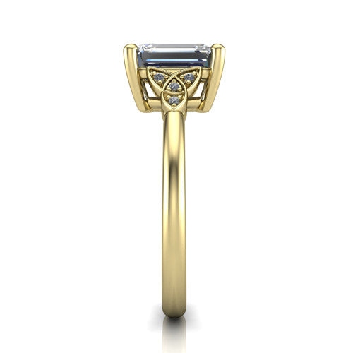 Lilith emerald solitaire engagement ring in 18K Yellow Gold, side profile showing the Celtic trinity knot accent and polished band