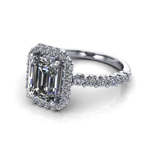 Mabel emerald halo engagement ring in Platinum, three-quarter perspective showing the emerald center diamond in a pave halo above a shared-prong pave band