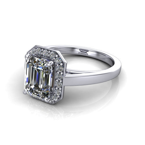 Coralie emerald-cut halo engagement ring in 14K White Gold, three-quarter perspective showing the emerald-cut center diamond, milgrain pavé halo, and polished band