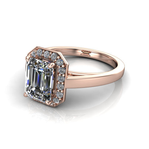 Coralie emerald-cut halo engagement ring in 14K Rose Gold, three-quarter perspective showing the emerald-cut center diamond, milgrain pavé halo, and polished band
