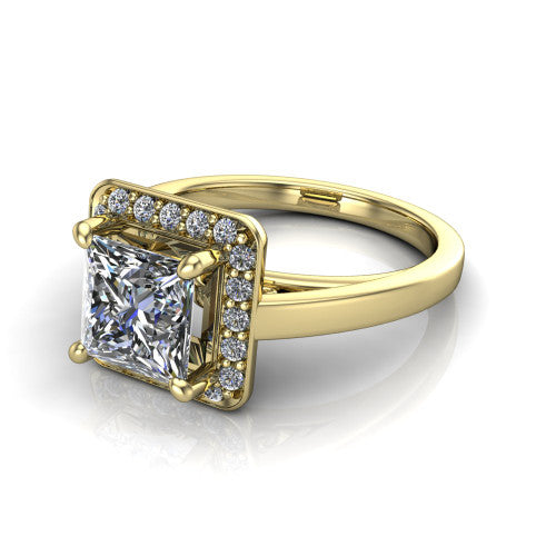 Coralie princess-cut halo engagement ring in 18K Yellow Gold, three-quarter perspective showing the princess-cut center diamond, milgrain pavé halo, and polished band