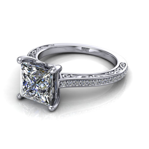 Nicole princess solitaire engagement ring in Platinum, three-quarter perspective showing the princess center diamond above a pave band with scrollwork engraving