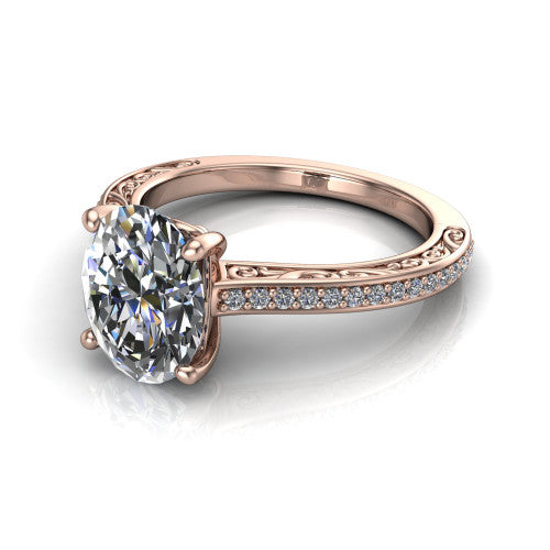 Nicole oval solitaire engagement ring in 18K Rose Gold, three-quarter perspective showing the oval center diamond above a pave band with scrollwork engraving
