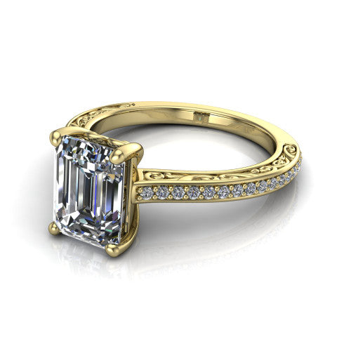 Nicole emerald solitaire engagement ring in 18K Yellow Gold, three-quarter perspective showing the emerald center diamond above a pave band with scrollwork engraving
