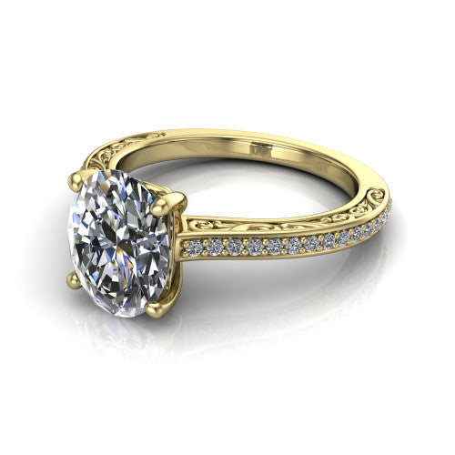 Nicole oval solitaire engagement ring in 14K Yellow Gold, three-quarter perspective showing the oval center diamond above a pave band with scrollwork engraving