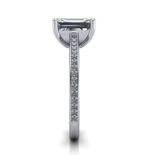 Nicole emerald solitaire engagement ring in Platinum, side profile showing the vintage scrollwork engraving on the band