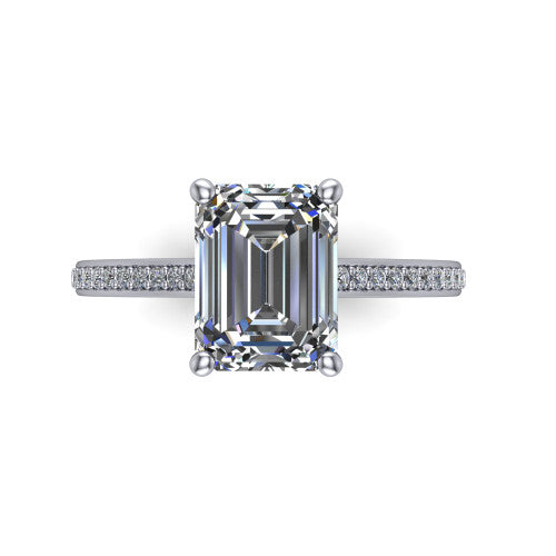 Nicole emerald solitaire engagement ring in Platinum, top-down view showing the four-prong emerald center diamond and pave band