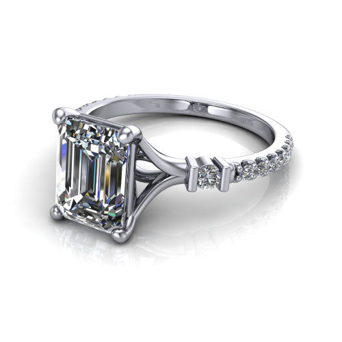 Arabella emerald solitaire engagement ring in Platinum, three-quarter perspective showing the emerald center diamond above a pave band with bezel-set shoulder accents
