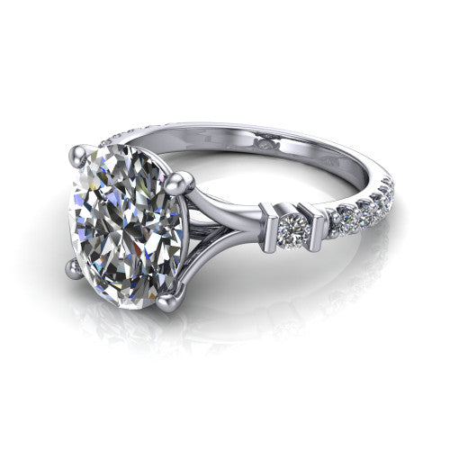 Arabella oval solitaire engagement ring in Platinum, three-quarter perspective showing the oval center diamond above a pave band with bezel-set shoulder accents