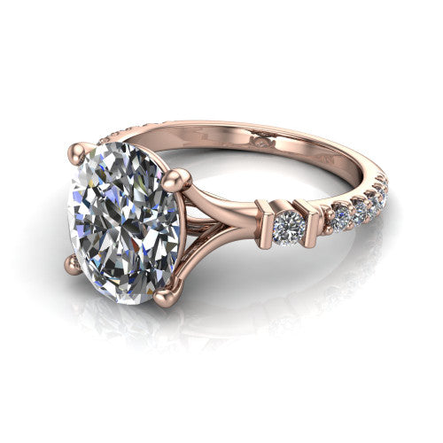 Arabella oval solitaire engagement ring in 14K Rose Gold, three-quarter perspective showing the oval center diamond above a pave band with bezel-set shoulder accents