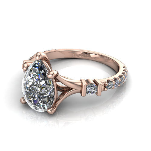 Arabella pear solitaire engagement ring in 14K Rose Gold, three-quarter perspective showing the pear center diamond above a pave band with bezel-set shoulder accents