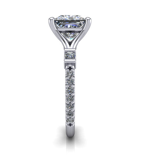 Arabella princess solitaire engagement ring in Platinum, side profile showing the bezel-set square accents and pave band