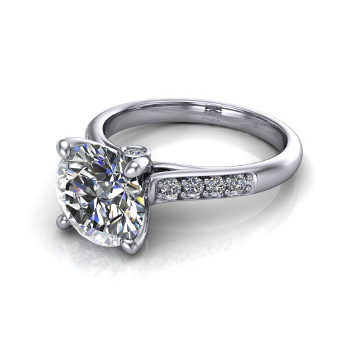 Nena round solitaire engagement ring in Platinum, three-quarter perspective showing the round center diamond above channel-set shoulders