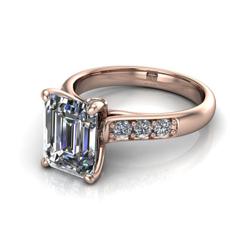 Nena emerald solitaire engagement ring in 18K Rose Gold, three-quarter perspective showing the emerald center diamond above channel-set shoulders