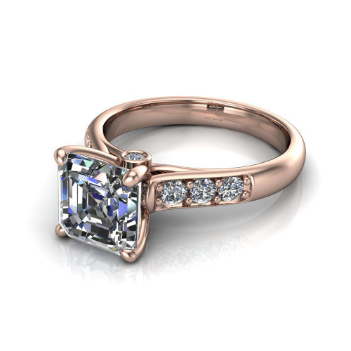 Nena square emerald solitaire engagement ring in 18K Rose Gold, three-quarter perspective showing the square emerald center diamond above channel-set shoulders