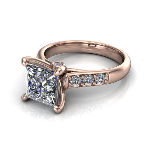 Nena princess solitaire engagement ring in 18K Rose Gold, three-quarter perspective showing the princess center diamond above channel-set shoulders