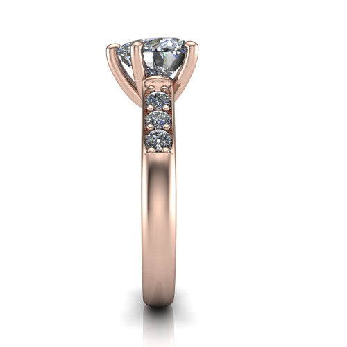 Nena heart solitaire engagement ring in 18K Rose Gold, side profile showing the channel-set shoulder diamonds