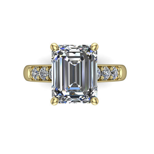 Nena emerald solitaire engagement ring in 18K Yellow Gold, top-down view showing the four-prong emerald center diamond and channel-set shoulders