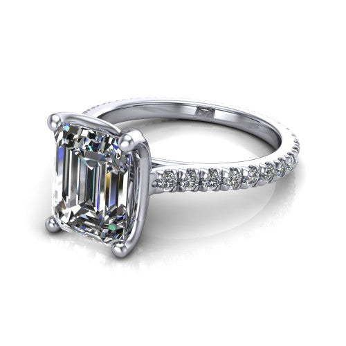 Honora emerald-cut solitaire engagement ring in Platinum, three-quarter perspective showing the emerald-cut center diamond, double-claw prongs, and pavé band