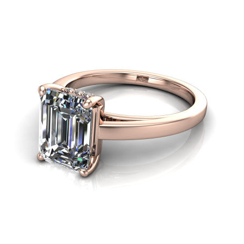 Itzel emerald-cut classic engagement ring in 14K Rose Gold, three-quarter perspective showing the emerald-cut center diamond, double-claw prongs, and polished band