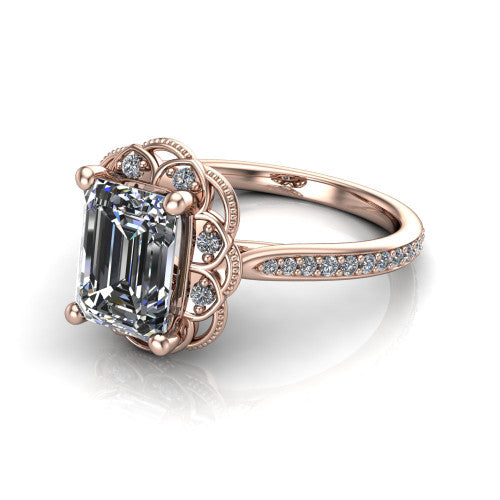 Mariana emerald-cut vintage halo engagement ring in 14K Rose Gold, three-quarter perspective showing the emerald-cut center diamond, ornate floral halo, and pavé band