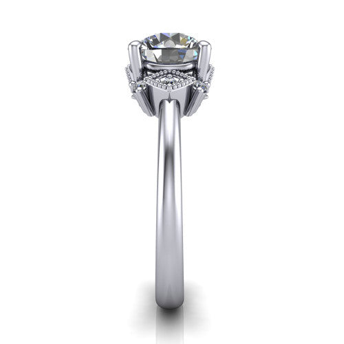 Harmony round three stone engagement ring in Platinum, side profile showing the diamond side clusters and polished band