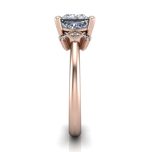 Harmony princess-cut three stone engagement ring in 14K Rose Gold, side profile showing the diamond side clusters and polished band