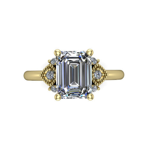Harmony emerald-cut three stone engagement ring in 18K Yellow Gold, top-down view showing the emerald-cut center diamond flanked by milgrain diamond clusters