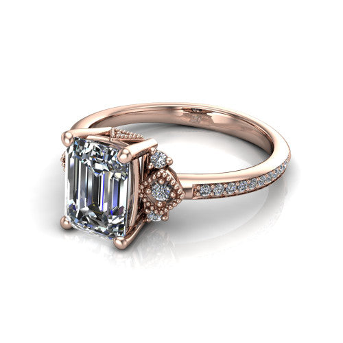 Presley emerald-cut three stone engagement ring in 18K Rose Gold, three-quarter perspective showing the emerald-cut center diamond, diamond side clusters, and pavé band
